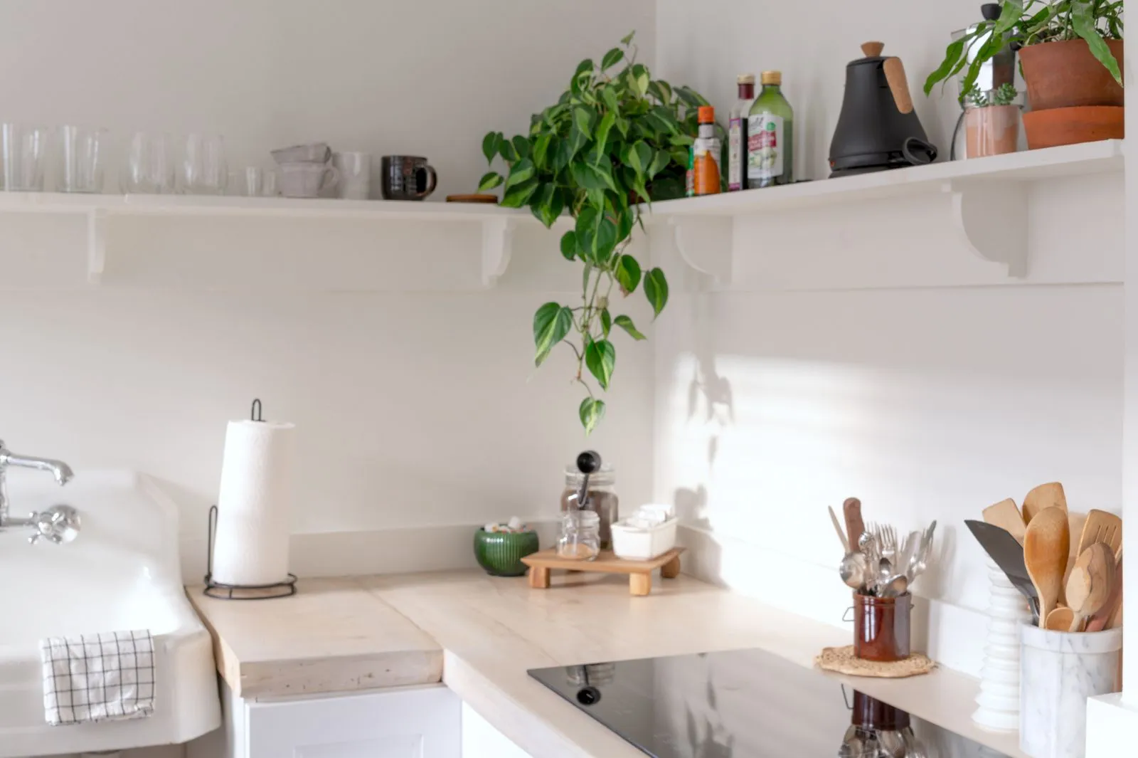 Bright and airy kitchen interior showcasing minimalist design and natural decor elements.